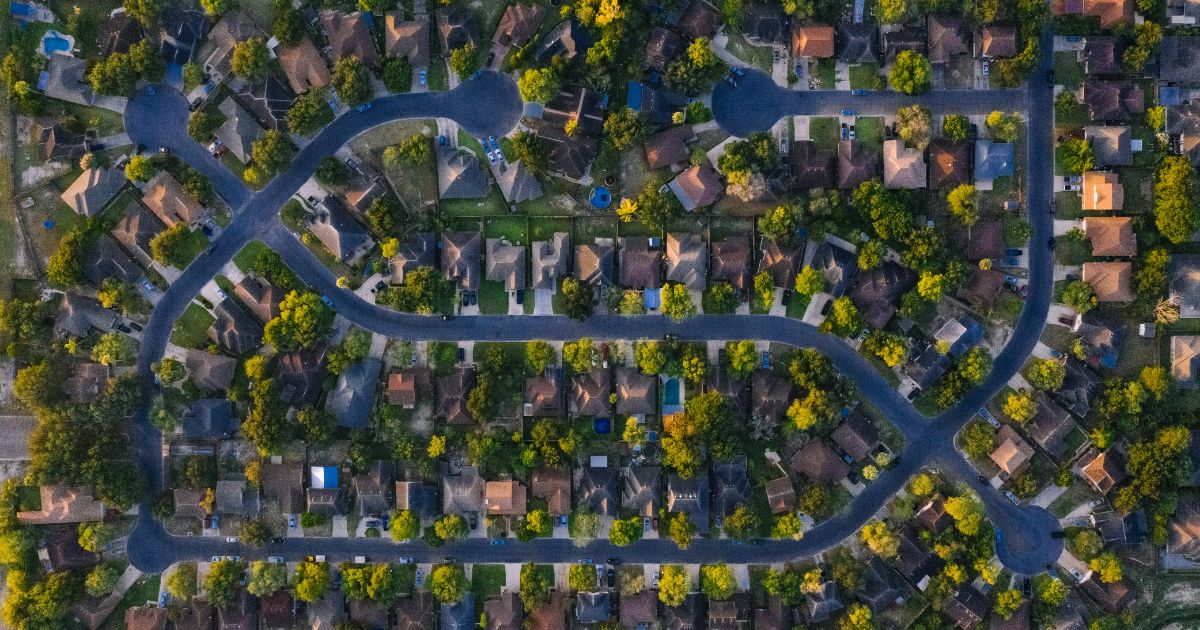 Aerial view of a San Diego residential neighborhood with winding streets and tree canopy, on a Lovery Real Estate guide to the VA loan Certificate of Eligibility process in San Diego.