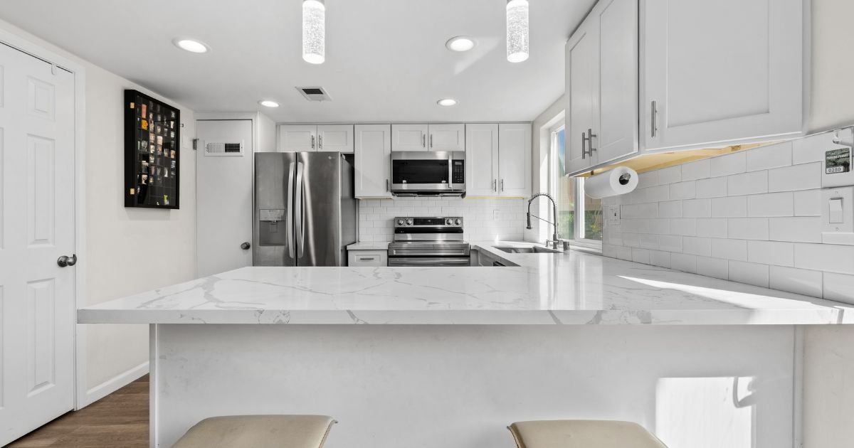 Updated kitchen with white cabinets and quartz counters in a San Diego home on a Lovery Real Estate guide to inheriting a house